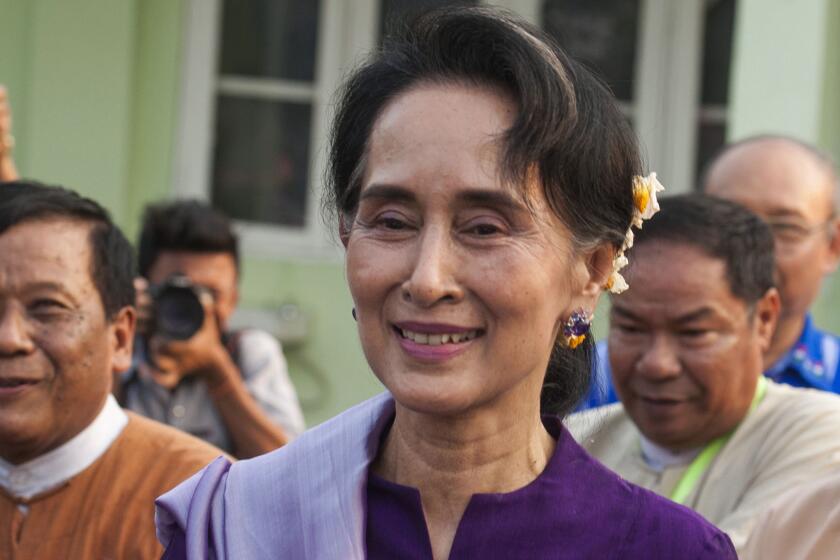Aung San Suu Kyi leaves after meeting members of parliament belonging to her political party, the National League for Democracy, in Naypyidaw, Myanmar.