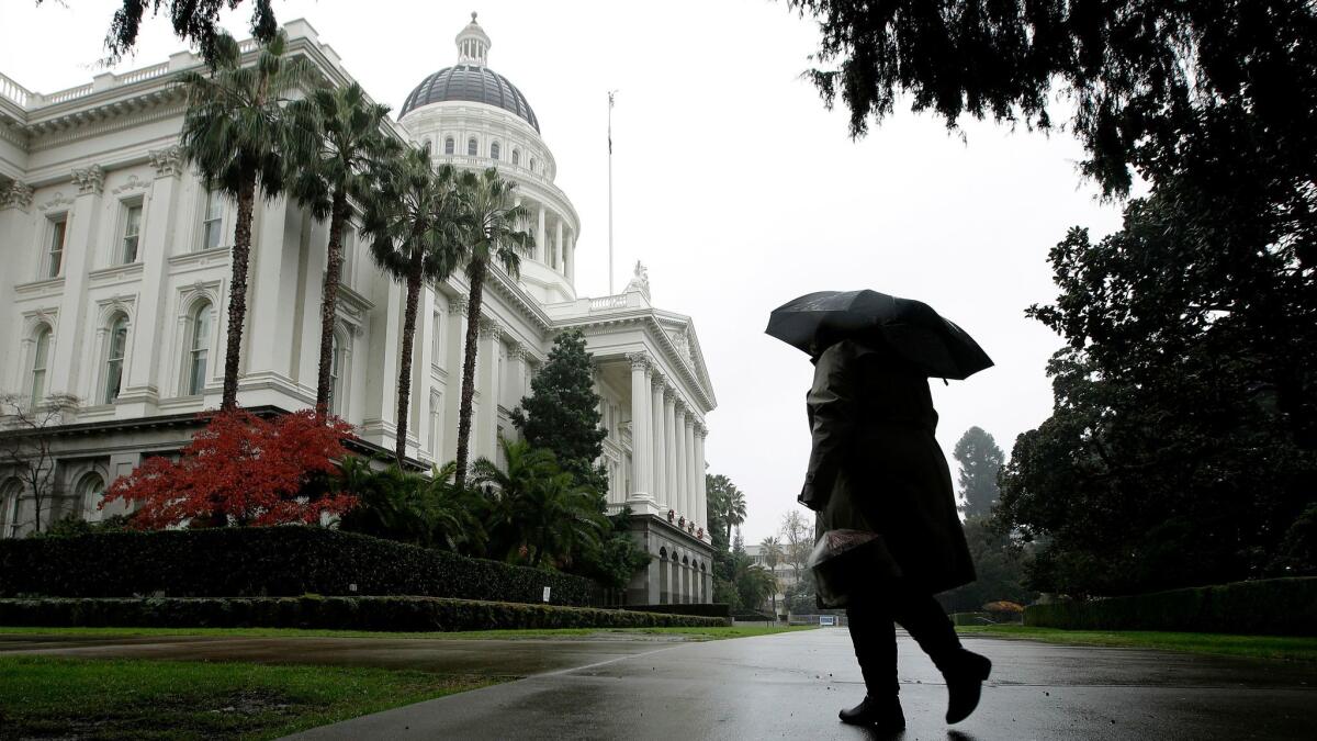 A rain storm passes over the California State Capitol in Sacramento on Dec. 8.