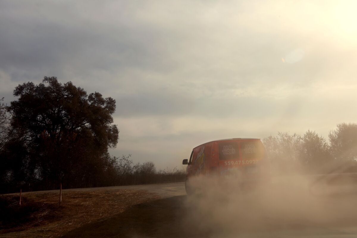 A van in a dusty field.