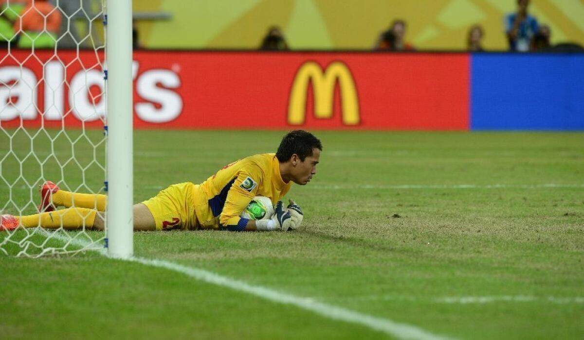 Tahiti's goal keeper Gilbert Meriel grabs a penalty kick, but his team is eliminated from the Confederations Cup in an 8-0 loss to Uruguay.