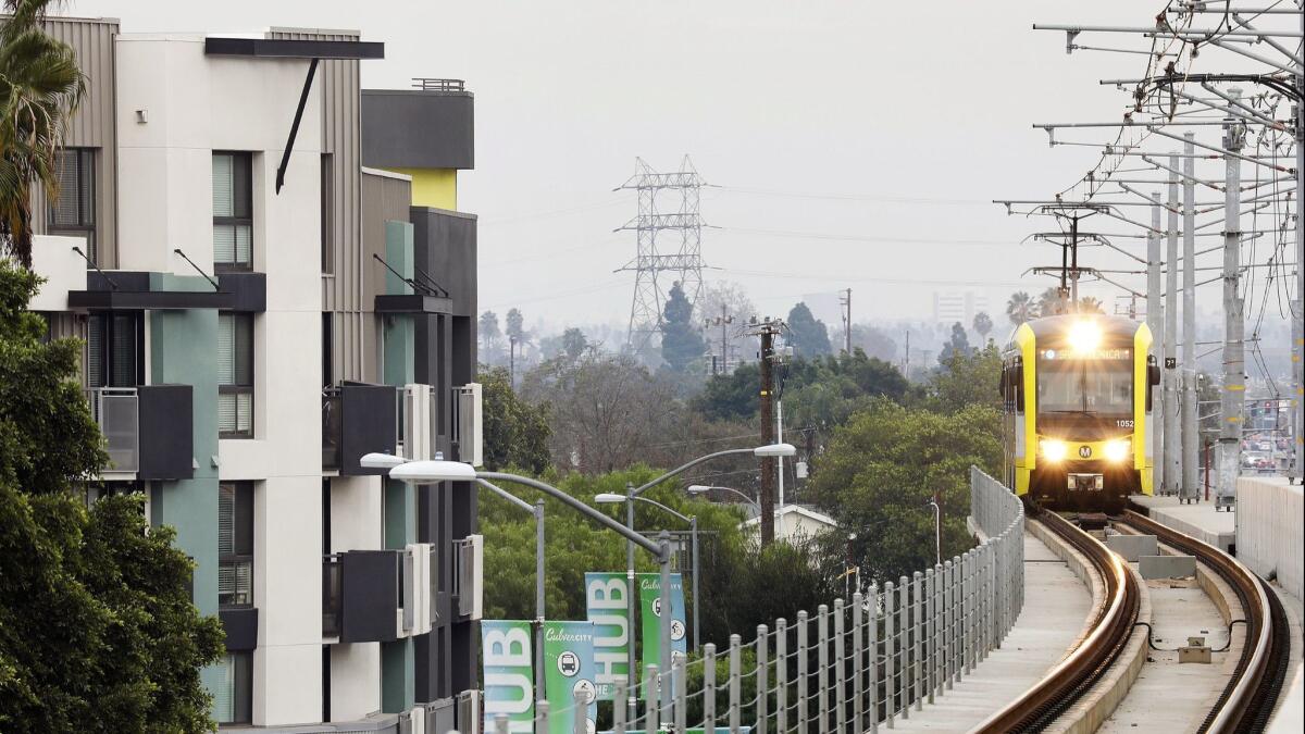 A Metro train passes by apartments in Culver City on Wednesday, January 3, 2017.