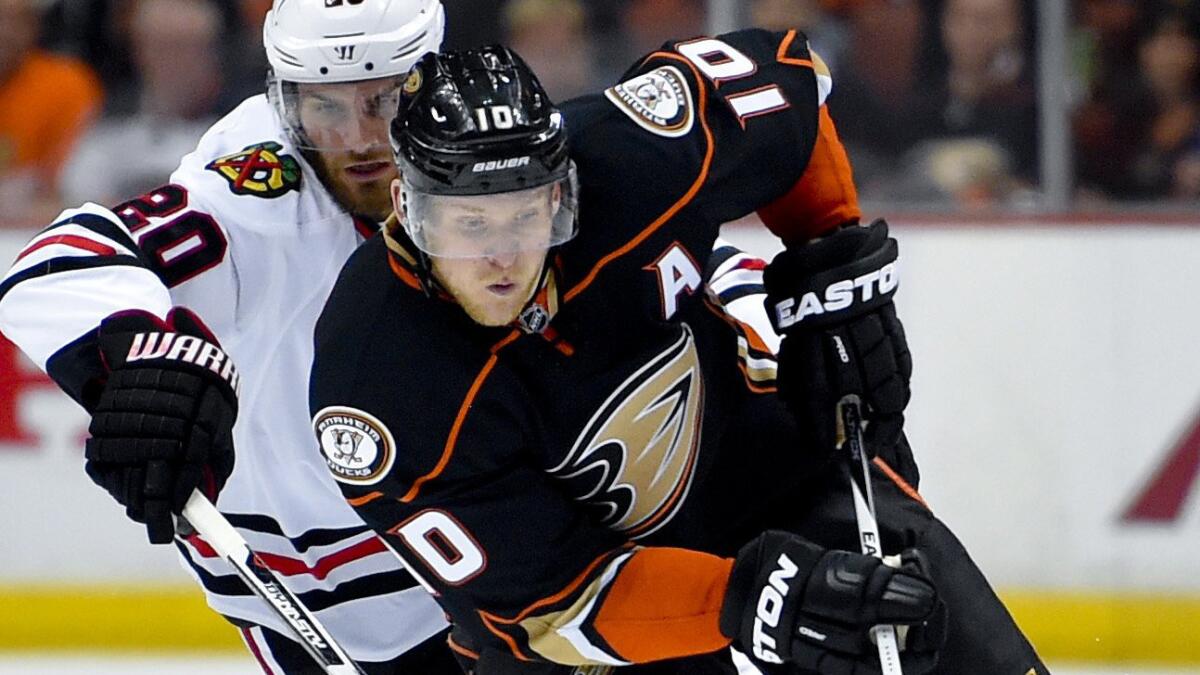 Ducks forward Corey Perry controls the puck in front of Chicago Blackhawks forward Brandon Saad during Game 2 of the Western Conference finals at Honda Center on May 19.