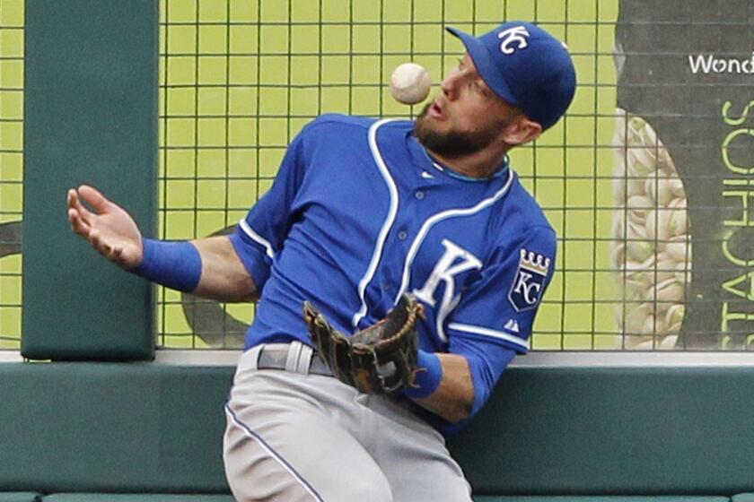 Kansas City Royals left fielder Alex Gordon bobbles a ball hit by Angels slugger Albert Pujols in the fifth inning of the Angels' 7-4 loss in 13 innings Saturday.