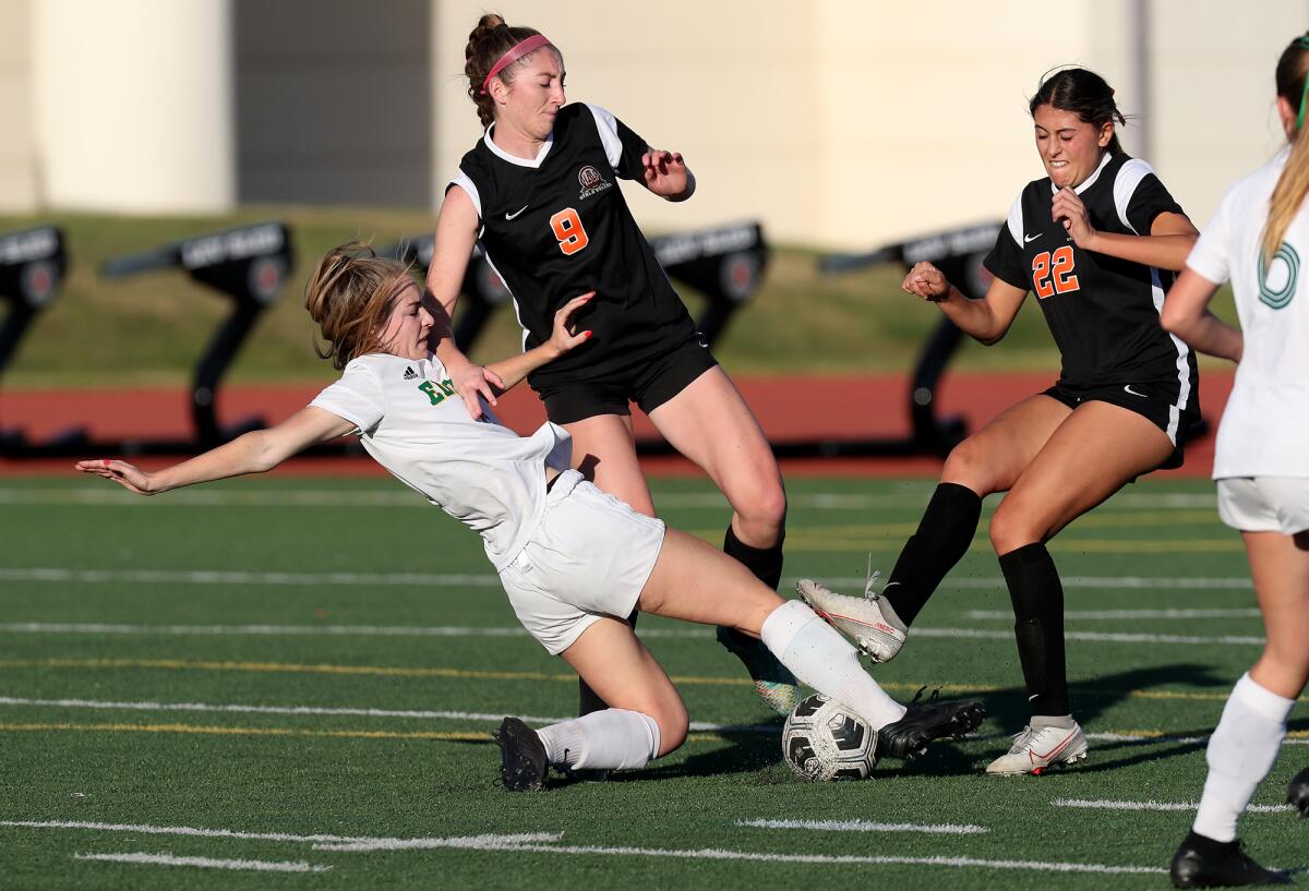 Edison's Nicole Scott, bottom left, competes against Huntington Beach during the second half of Friday's match. 