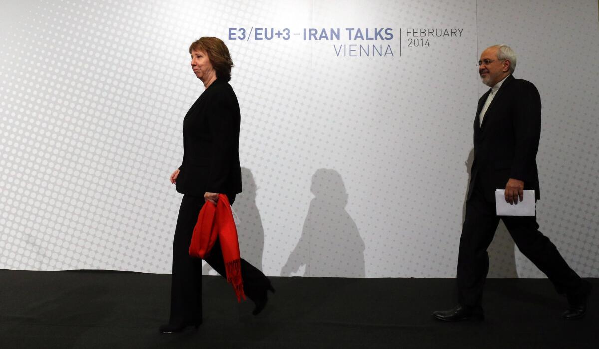 European Union foreign policy chief Catherine Ashton and Iranian Foreign Minister Mohammad Javad Zarif arrive to speak with reporters after closed-door nuclear talks in Vienna.