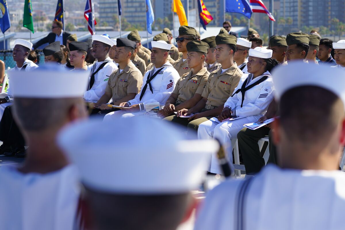 Service members line up in uniform at a ceremony.
