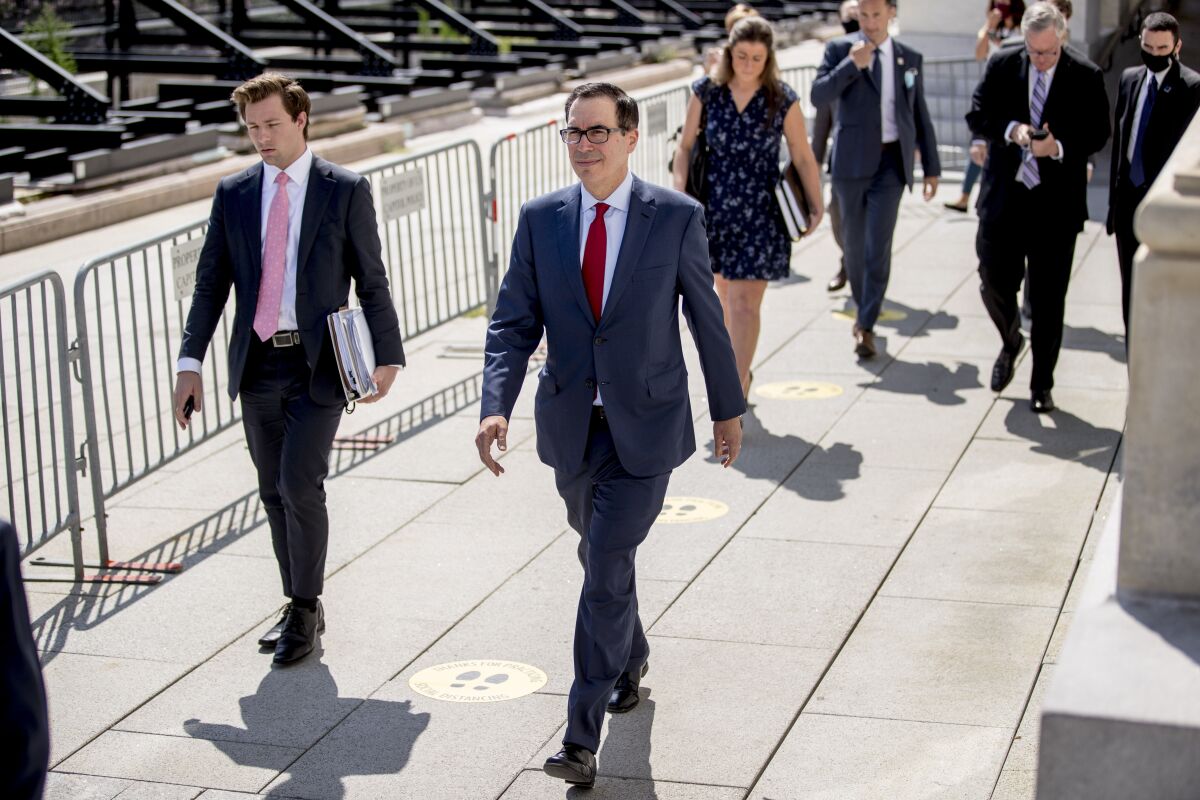 Treasury Secretary Steven Mnuchin, center, and President Donald Trump's Chief of Staff Mark Meadows, second from right, leave following a meeting with House Speaker Nancy Pelosi of Calif. and Senate Minority Leader Sen. Chuck Schumer of N.Y. as they continue to negotiate a coronavirus relief package on Capitol Hill in Washington, Friday, Aug. 7, 2020. (AP Photo/Andrew Harnik)
