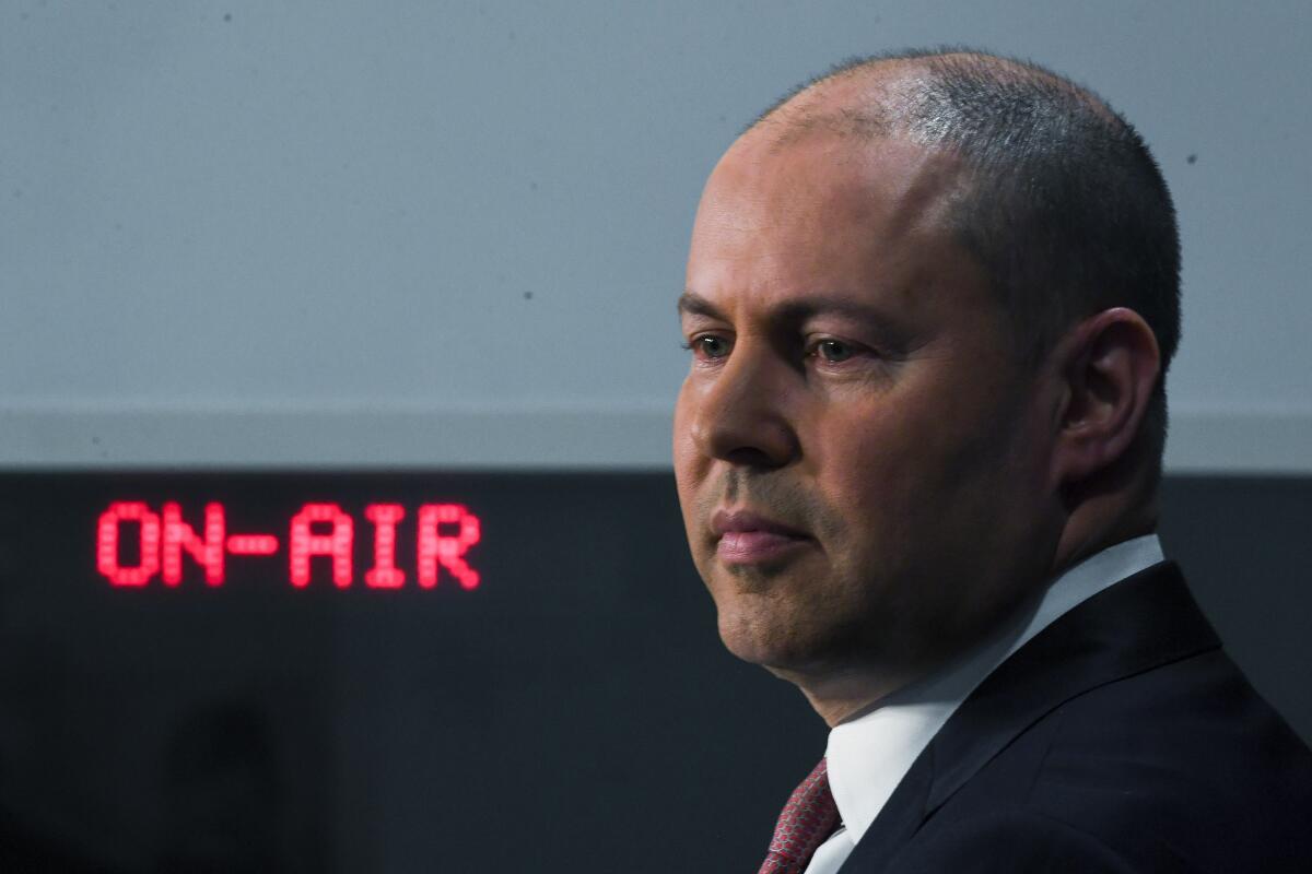 Australian Treasurer Josh Frydenberg speaks to the media during a press conference at Parliament House in Canberra, Tuesday, Dec. 8, 2020. Australia’s government will reveal legislation in Parliament on Wednesday that would make Facebook and Google pay for journalism. (Lukas Coch/AAP Image via AP)