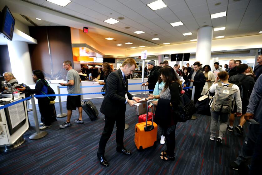 LOS ANGELES, CA -- TUESDAY, DEC. 12, 2016: Passengers line up to board American Airlines 2381 flight to Orlando at LAX. The key to a profitable airline is the turnaround, getting a full plane into the terminal gate, unloading it, cleaning it, refueling it and getting it in the air again. (Allen J. Schaben / Los Angeles Times)