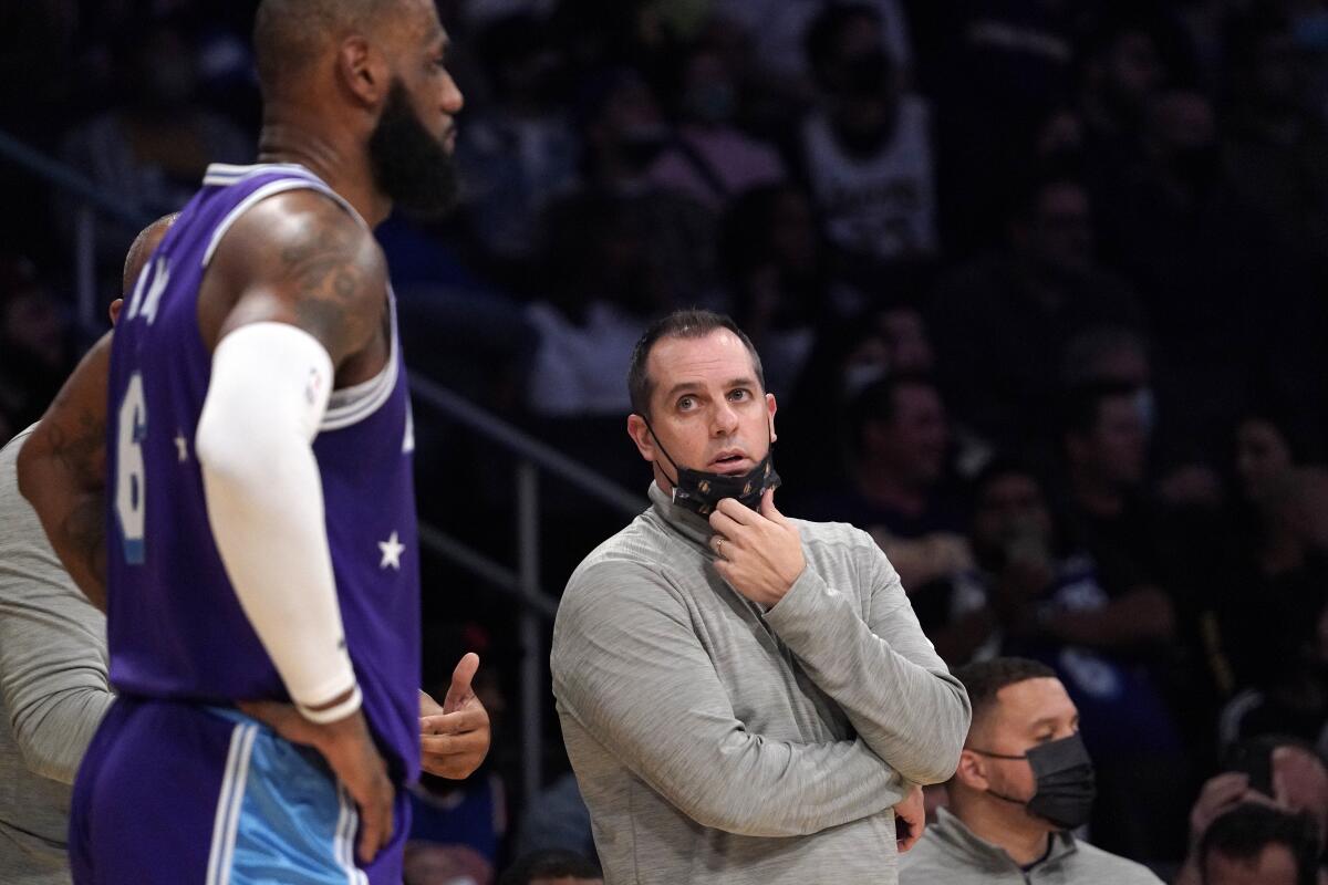 Lakers coach Frank Vogel, right, talks to LeBron James during a win over the New York Knicks.