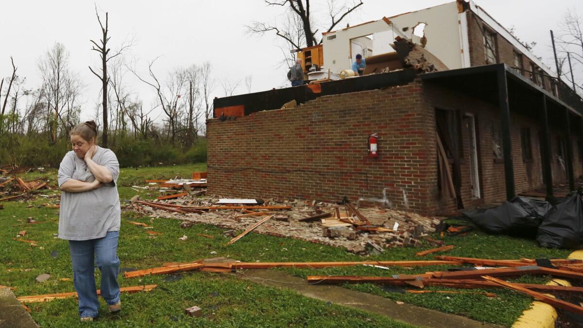 Keisha Turner surveys the damage done to her son's apartment on March 20 after a violent storm swept through Jacksonville, Ala.