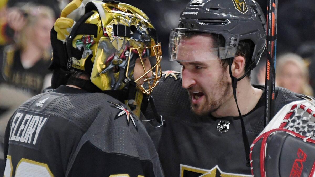 Vegas Golden Knights' Marc-Andre Fleury, left, and Mark Stone celebrate on the ice after the team's 4-1 victory over the Dallas Stars on Tuesday in Las Vegas.