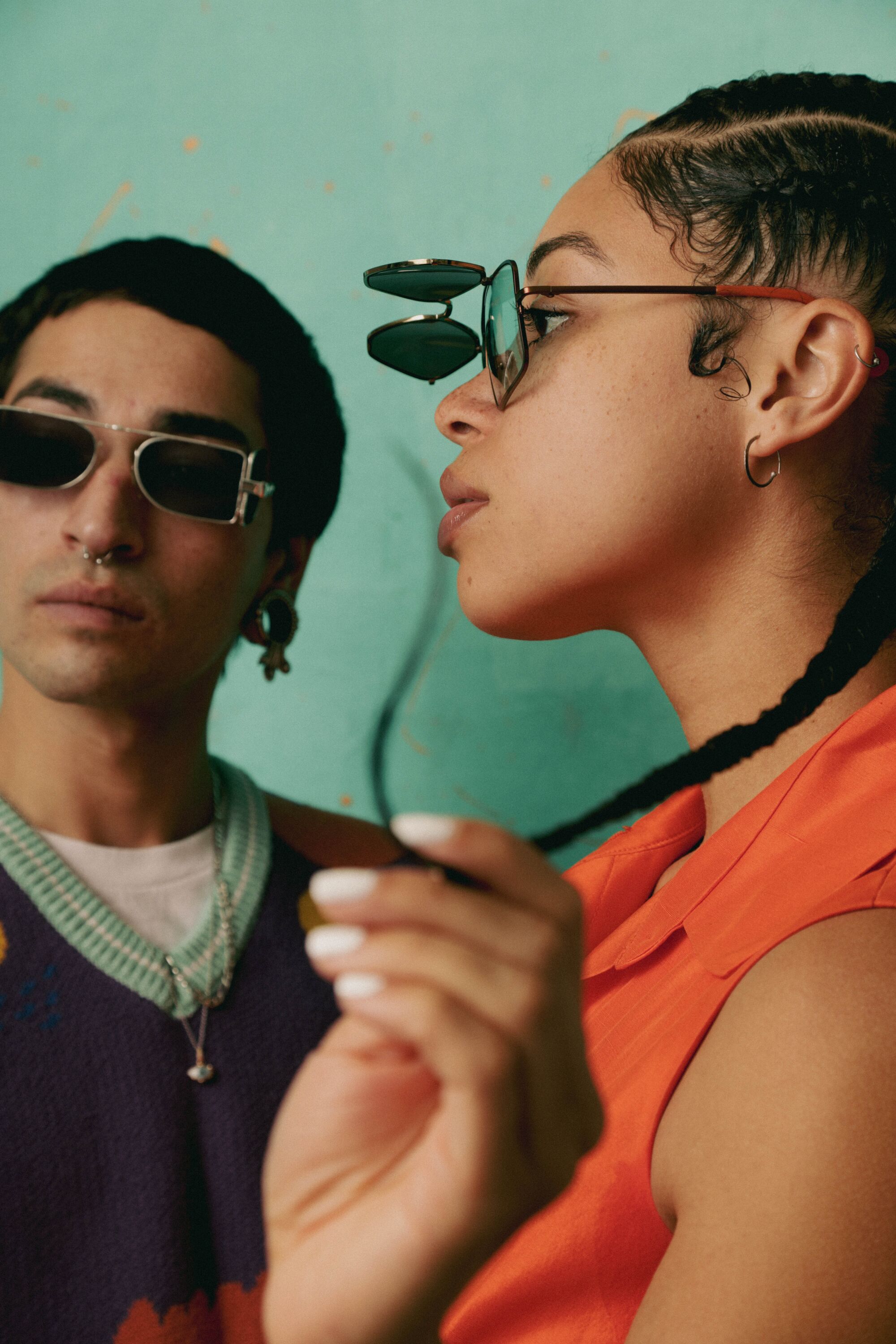 Gabrielle Ebron and Xochi Chimalli pose in front of a teal backdrop wearing l.a.Eyeworks sunglasses