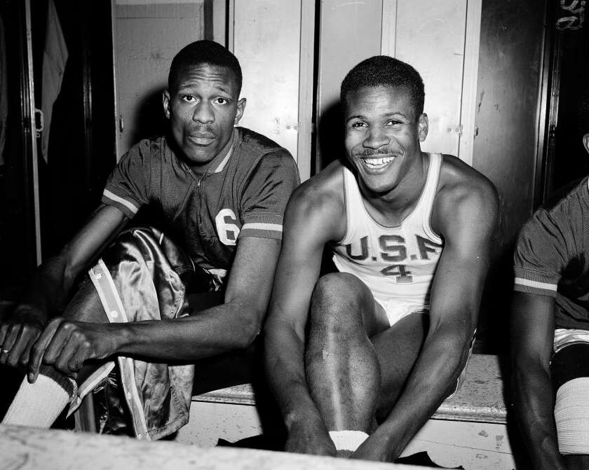 Bill Russell and K.C. Jones in a locker room in a black-and-white photo,
