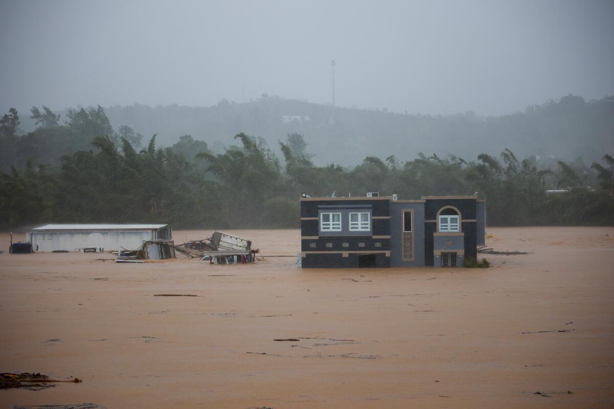 A home submerged in floodwaters.