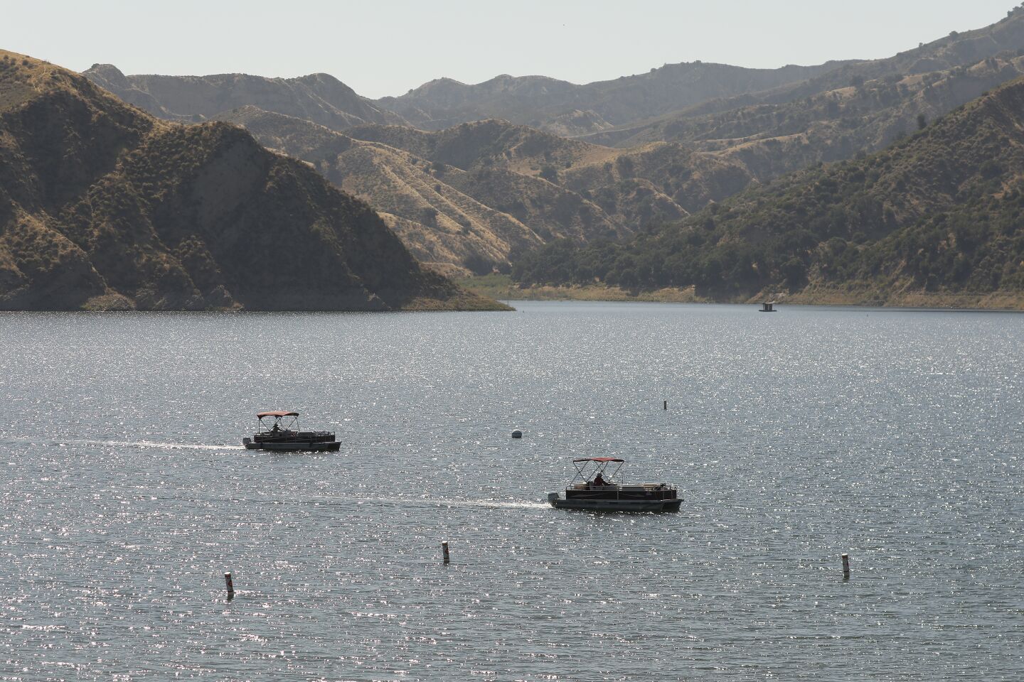Boats return with rescuers on Lake Piru as it is learned that a Ventura County Sheriff's dive team located a body.