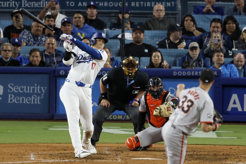 Los Angeles, CA - April 03: Dodgers designated hitter Shohei Ohtani, #17, hits his first home run off of Giants pitcher Taylor Rogers, # 33, in the seventh inning at Dodger Stadium in Los Angeles Wednesday, April 3, 2024. (Allen J. Schaben / Los Angeles Times)