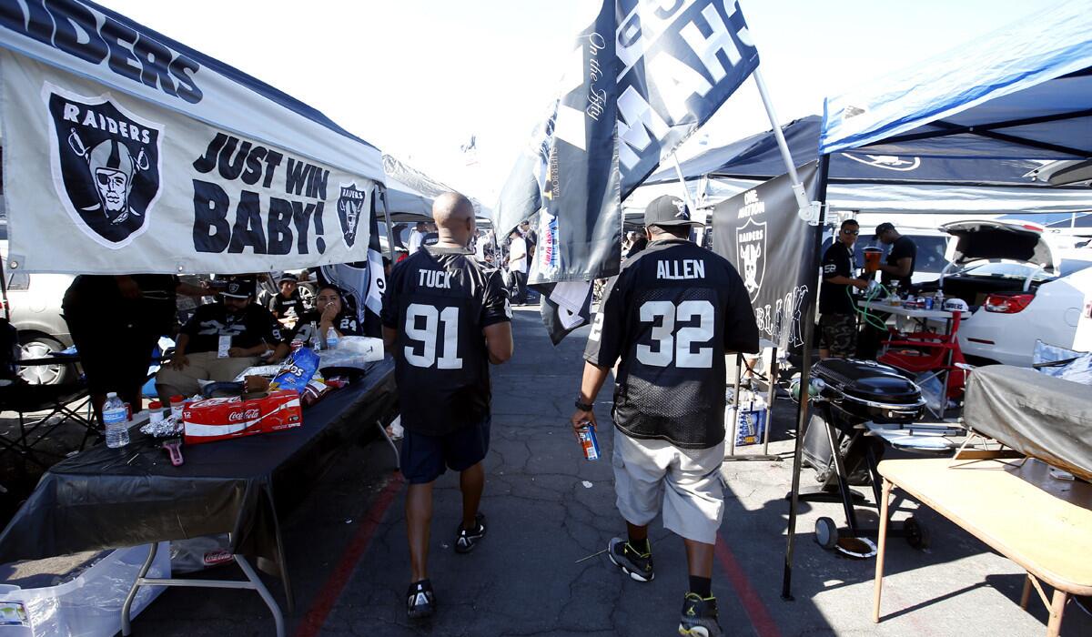 Fans tailgate before an NFL football game between the Oakland Raiders and the Baltimore Ravens on Sunday.