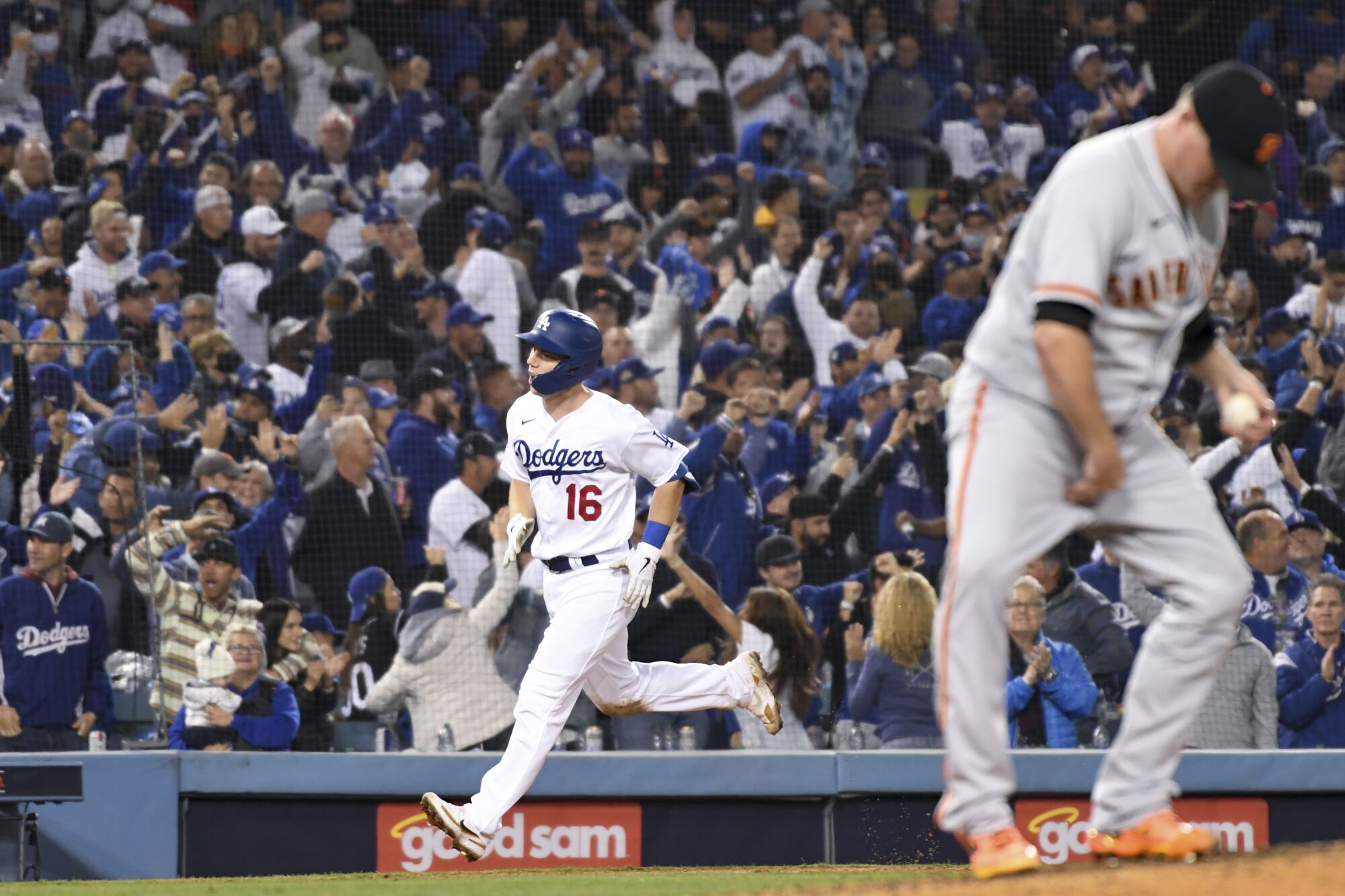 Dodgers' Will Smith rounds the bases after hitting a two-run home run off of  Giants relief pitcher Jake McGee