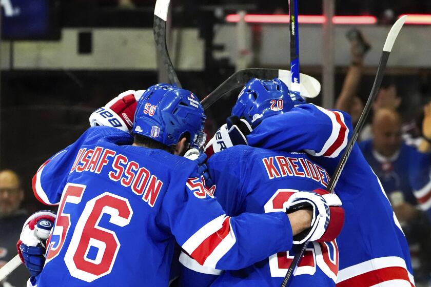 New York Rangers defenseman Erik Gustafsson (56), left wing Jimmy Vesey and others celebrate center Vincent Trocheck's goal against the Carolina Hurricanes during the first period in Game 1 of an NHL hockey Stanley Cup second-round playoff series, Sunday, May 5, 2024, in New York. (AP Photo/Julia Nikhinson)