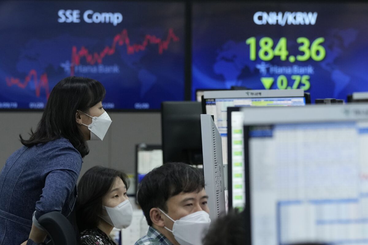 Currency traders watch monitors at the foreign exchange dealing room of the KEB Hana Bank headquarters in Seoul, South Korea, Friday, Oct. 15, 2021. Asian shares were higher Friday after technology companies powered the biggest gain on Wall Street since March. (AP Photo/Ahn Young-joon)