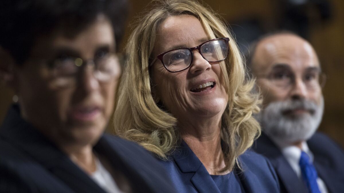 Christine Blasey Ford, center, flanked by attorneys Debra Katz and Michael Bromwich, testifies during the Senate Judiciary Committee hearing on Sept. 27.