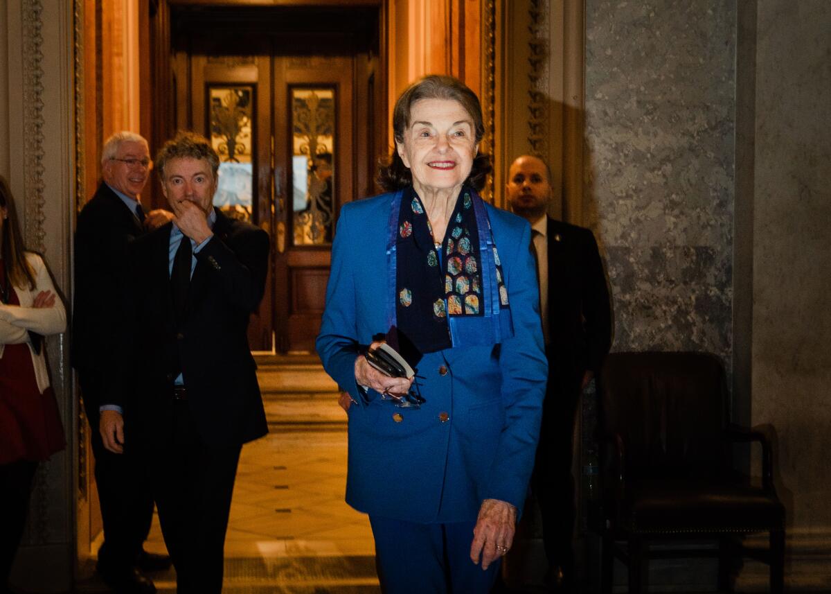 Sen. Dianne Feinstein smiles in a blue suit.