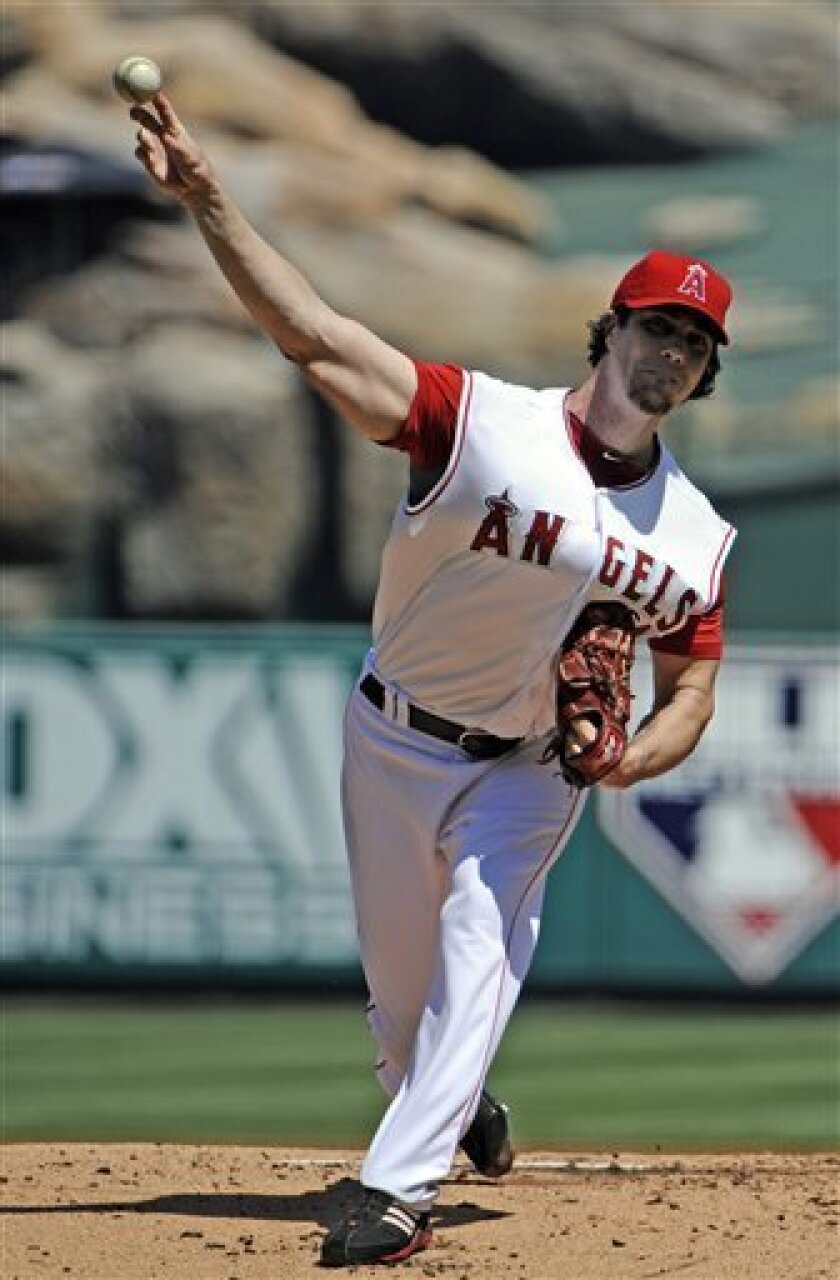 Los Angeles Angels pitcher Dan Haren delivers during the first inning of a baseball game against the Seattle Mariners Sunday, Sept. 12, 2010 in Anaheim, Calif. (AP Photo/Denis Poroy)