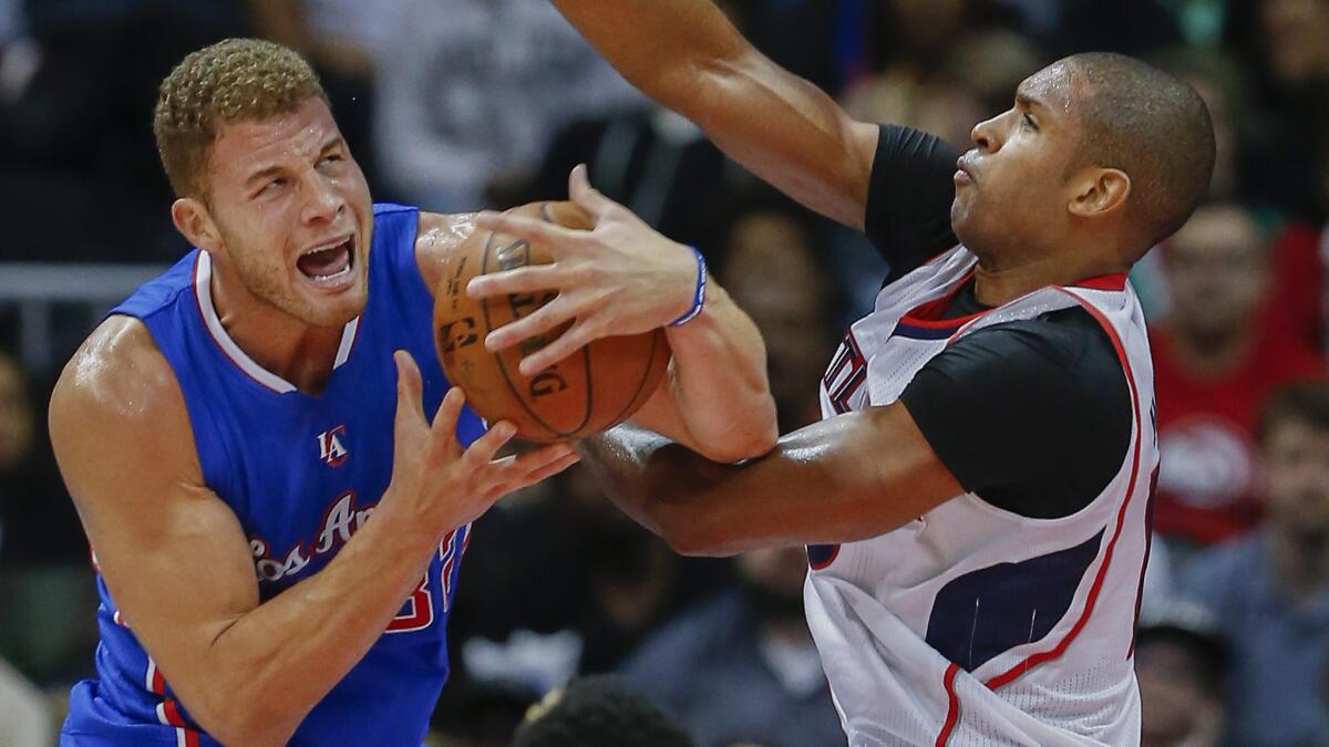 Clippers forward Blake Griffin, left, tries to put up a shot over Atlanta Hawks center Al Horford during the Clippers' 107-104 road loss Dec. 23.