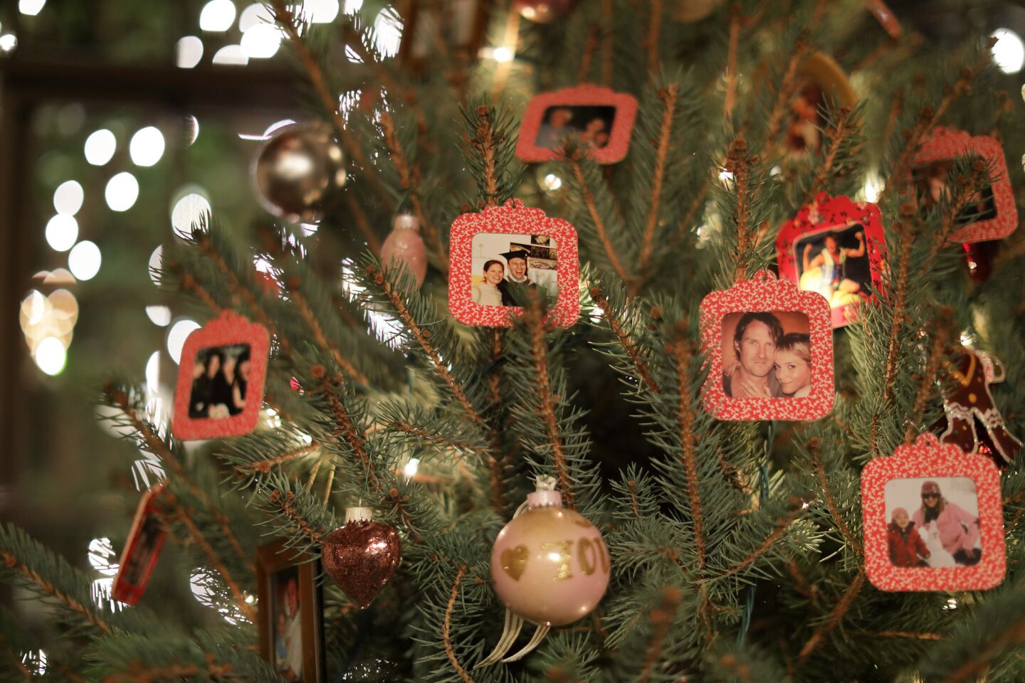 The Christmas tree is decorated with photos of four generations of family.