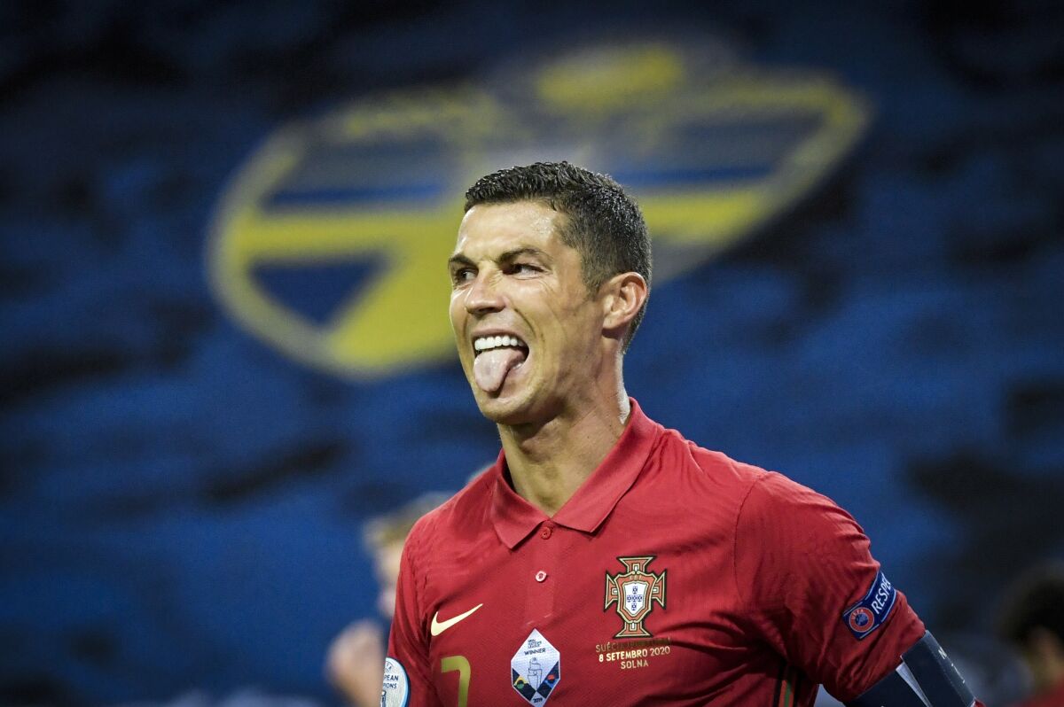 FILE - In this Sept. 8, 2020 file photo, Portugal's Cristiano Ronaldo sticks out his tongue during the Portugal against Sweden UEFA Nations League soccer match at Friends Arena in Stockholm, Sweden. The Portuguese soccer federation says on Tuesday, Oct. 13 Cristiano Ronaldo has tested positive for the coronavirus. The federation says Ronaldo is doing well and has no symptoms. He has been dropped from the country's Nations League match against Sweden on Wednesday. (Janerik Henriksson/TT via AP, file)