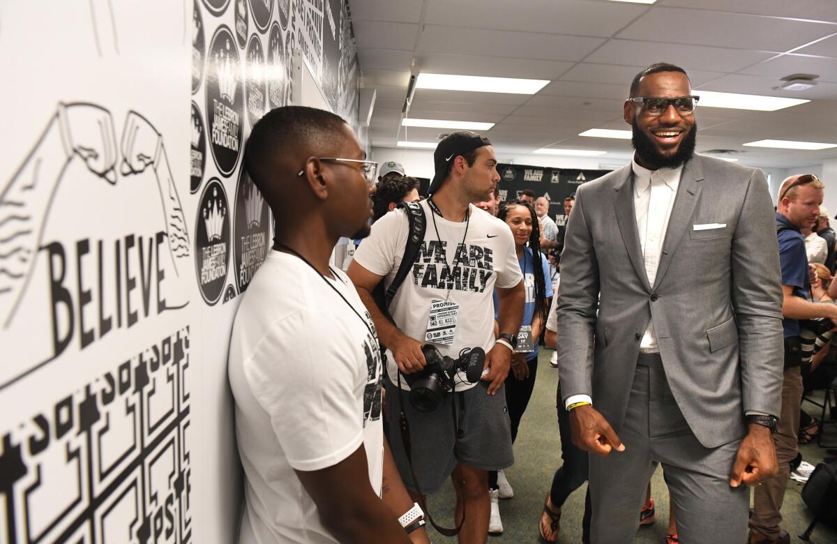 LeBron James finishes a news conference in a classroom at the I Promise School in Akron, Ohio, on July 20.