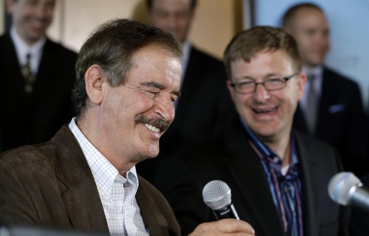 Former Mexican President Vicente Fox, left, speaks as Jamen Shively of Diego Pellicer looks on during a news conference May 30, 2013, in Seattle.