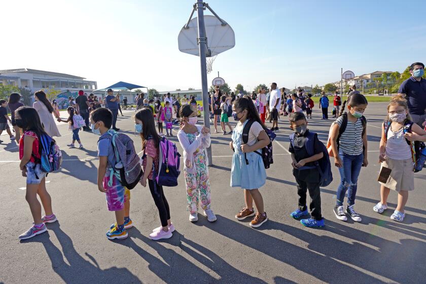 Chula Vista, CA - July 21: On Wednesday, July 21, 2021 at Enrique S. Camarena Elementary School in Chula Vista, CA., it’s the first day back at school and school children line up behind the chair that list their assigned teacher and classroom. (Nelvin C. Cepeda / The San Diego Union-Tribune)