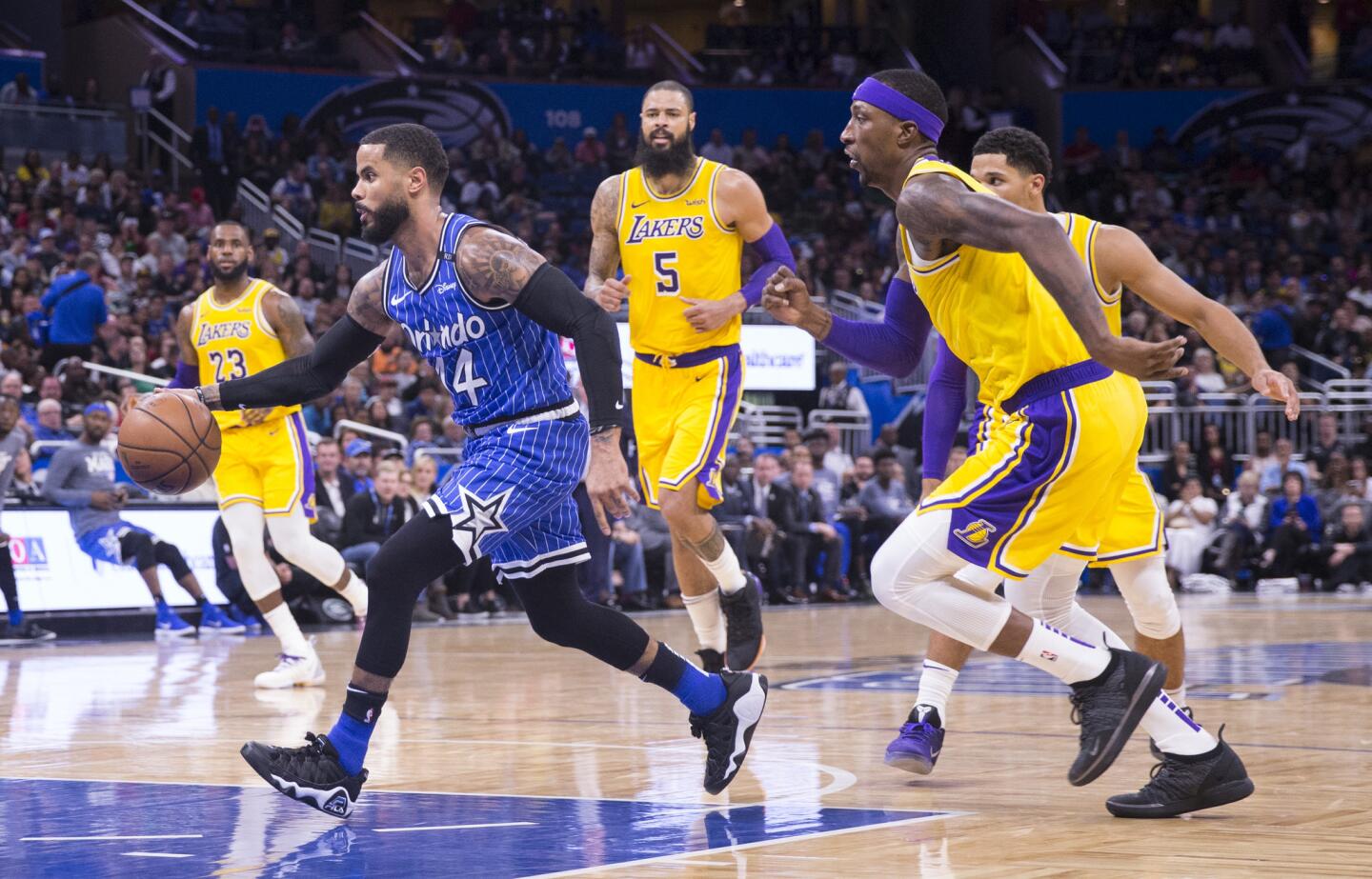 Orlando Magic guard D.J. Augustin (14) dribbled past Los Angeles Lakers guard Kentavious Caldwell-Pope, right, and center Tyson Chandler (5) during the second half of an NBA basketball game, Saturday, Nov. 17, 2018, in Orlando, Fla. The Magic won 130-117. (AP Photo/Willie J. Allen Jr.)
