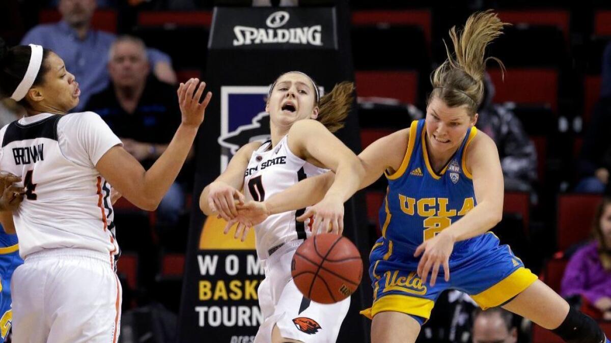 UCLA's Kari Korver breaks for a loose ball in front of Oregon State's Mikayla Pivec and Breanna Brown during a Pac-12 tournament game on March 4.