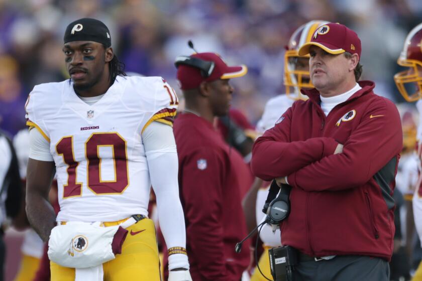 Washington quarterback Robert Griffin III, left, stands on the sidelines with Coach Jay Gruden in November.