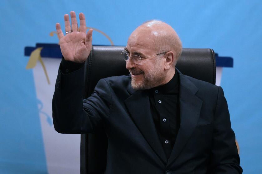 Iran's hard-line parliament speaker, Mohammad Bagher Qalibaf waves to the media while registering his name as candidate for the June 28 presidential election at the Interior Ministry, in Tehran, Iran, Monday, June 3, 2024. Monday marked the last day of registration for the competition. Other politicians have been rumored as potential candidates in the vote to replace Ebrahim Raisi, who died in a helicopter crash with seven others on May 19. (AP Photo/Vahid Salemi)