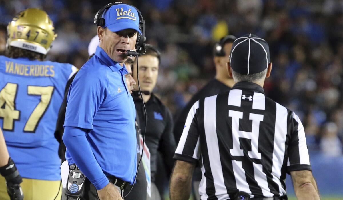 UCLA Coach Jim Mora, who was penalized 15 yards during the first quarter of Saturday's game, displays a calmer side in the second half.