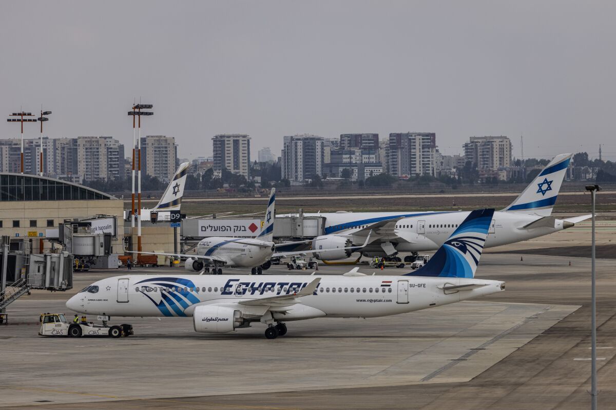 An EgyptAir Airbus 320 aircraft is seen on the tarmac at Ben Gurion International Airport in Lod, Israel, Sunday, Oct. 3, 2021. Egypt's national carrier Sunday made its first official direct flight from Cairo to Israel since the two countries signed an historic 1979 peace treaty as an EgyptAir jet landed at Tel Aviv's Ben Gurion Airport. (AP Photo/Tsafrir Abayov)