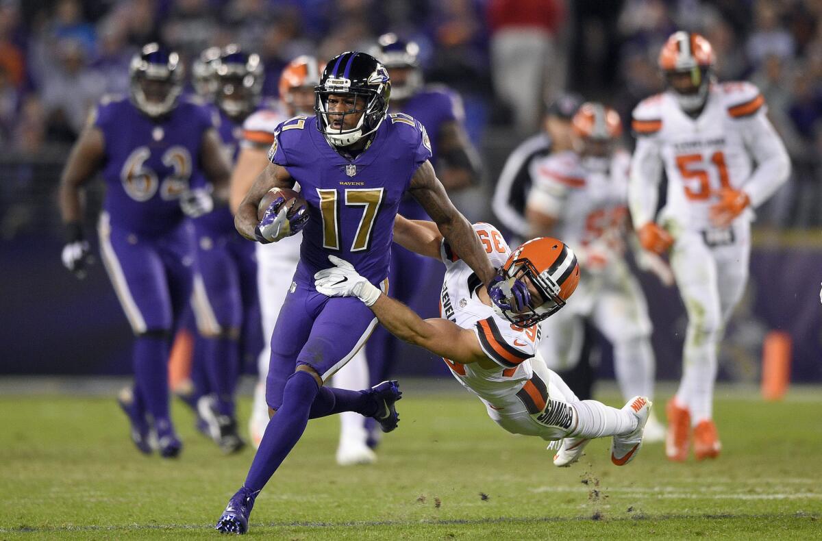 Ravens wide receiver Mike Wallace (17) tries to break free from Cleveland Browns defensive back Ed Reynolds II after a second half catch on Nov. 10.