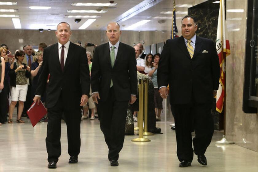 Senate leader Darrell Steinberg, (D-Sacramento), Gov. Jerry Brown and Assembly Speaker John Perez (D-Los Angeles) walk to a news conference to discuss the budget compromise.
