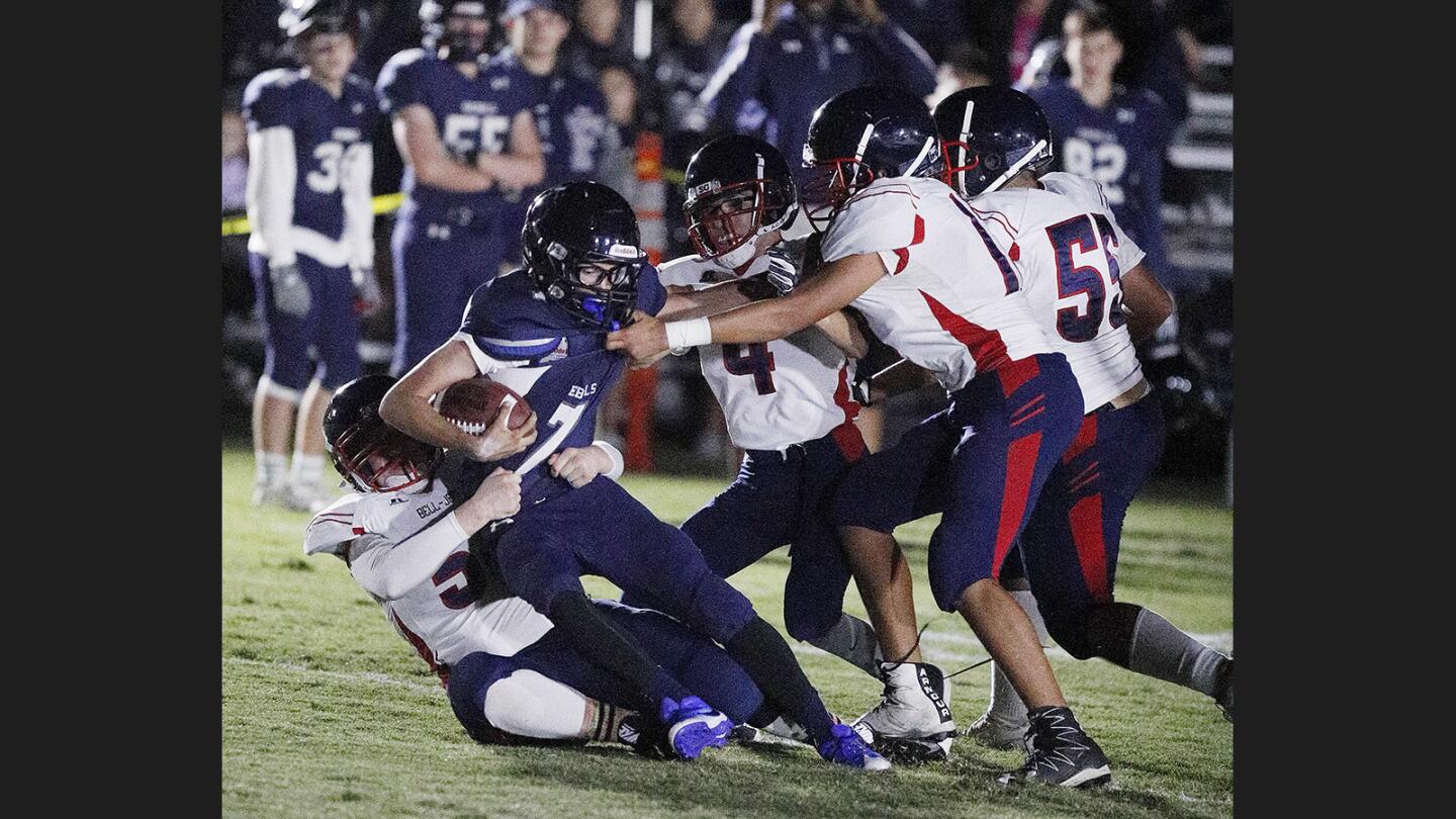 Flintridge Prep's Alex Payne is grabbed and tacked by several Bell-Jeff defenders in a non-league football game at Flintridge Prep in La Canada Flintridge on Friday, September 22, 2017.