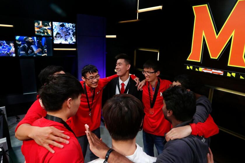LOS ANGELES, CA-MARCH 28, 2017: Members of the "League of Legends" team from the University of Maryland, huddle up after their victory over the University of Illinois in the Big Ten Network "League of Legends" championship in the Battle Theater at North American League Championship Arena at Riot Games in Los Angeles on March 28, 2017. Maryland won the best of five contest by a score of 3-0. (Mel Melcon/Los Angeles Times)