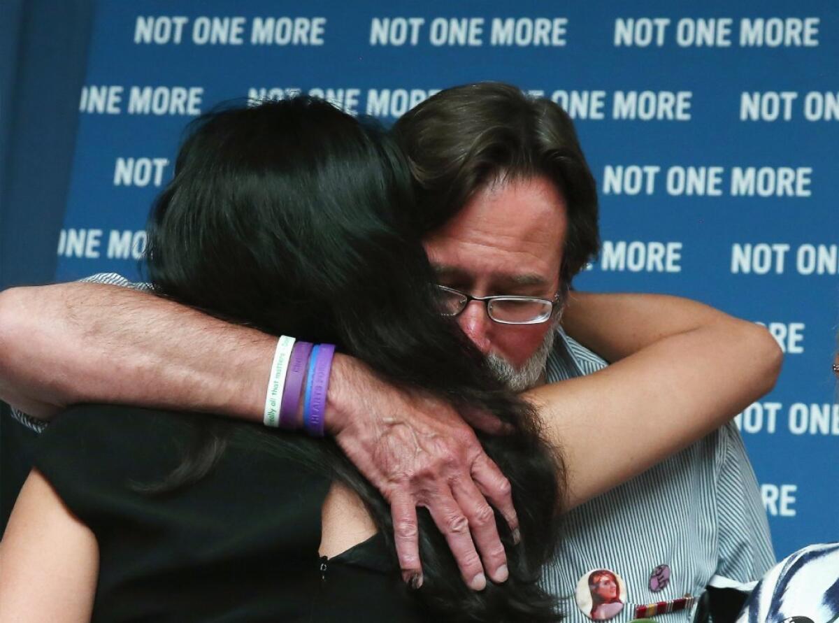 Roxanna Green, mother of Christina Taylor Green, who was shot and killed during a shooting rampage in Tucson, receives a hug from Richard Martinez, whose son Christopher Michaels-Martinez was recently shot and killed during a shooting near UC San Barbara.