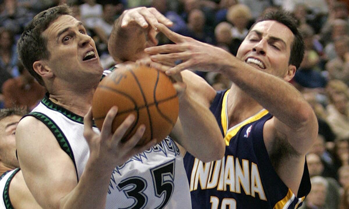 Minnesota Timberwolves forward Mark Madsen, left, grabs a rebound in front of Indiana Pacers forward Jeff Foster during a game in 2006. Madsen denies accusations that he purposefully missed shots in the Timberwolves' 2006 regular-season finale in order to improve the team's draft prospects.
