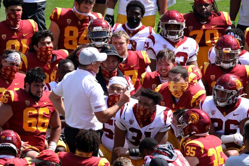LOS ANGELES, CA - APRIL 17, 2021 - - USC's coach Clay Helton talks to players at the end of USC's Spring Football Game.