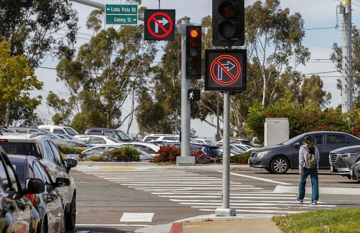 Two large digital signs warn drivers they can't turn right into a pedestrian crosswalk in San Diego.