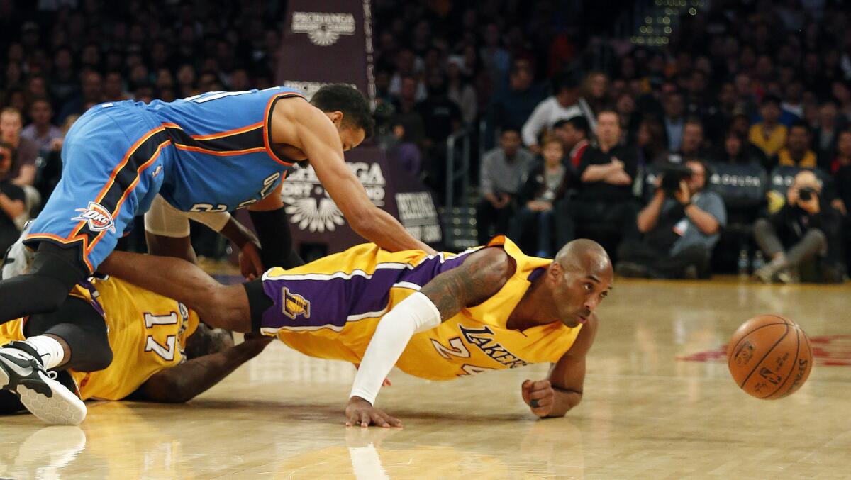 Lakers guard Kobe Bryant and center Roy Hibbert go after a loose ball along with Thunder guard Andre Roberson during their Dec. 23 game at Staples Center.