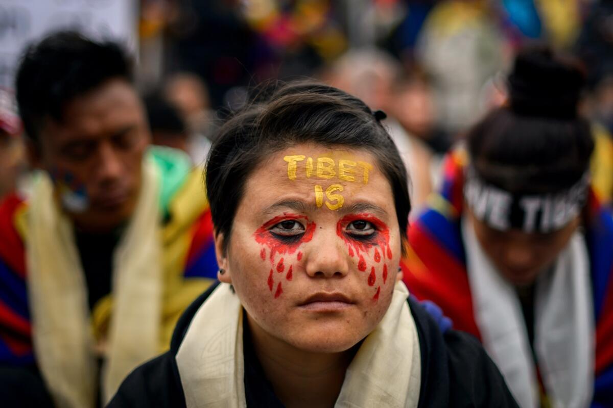Demonstrators' protests against alleged Chinese rights abuses in Tibet did little to dissuade the U.N. General Assembly on Tuesday from electing China to a three-year term on the world body's Human Rights Council. This protester was taking part in a demonstration outside the U.N. building in Geneva in October.